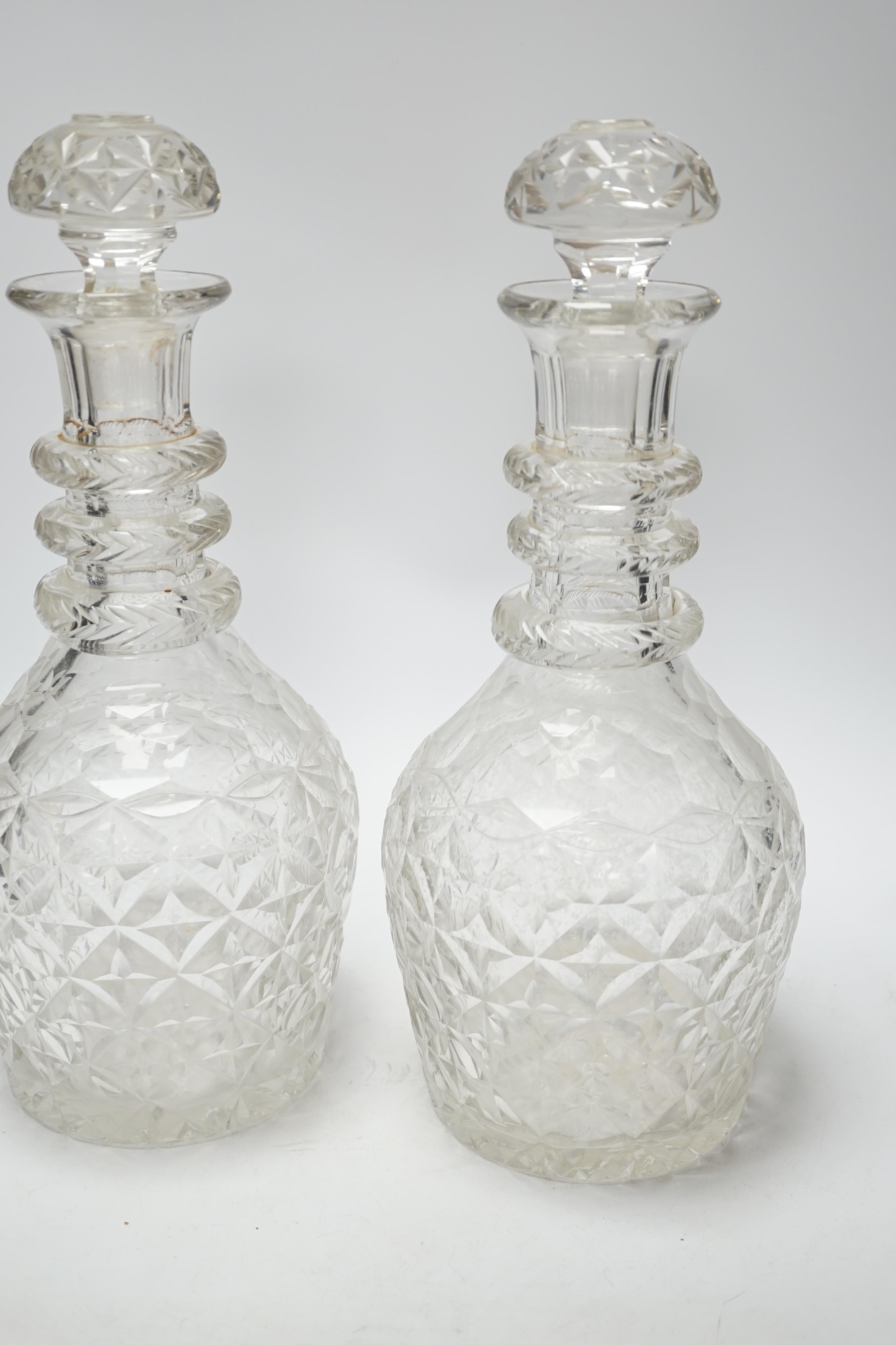 A pair of large Regency style cut glass magnum decanters and stoppers, 39cm high